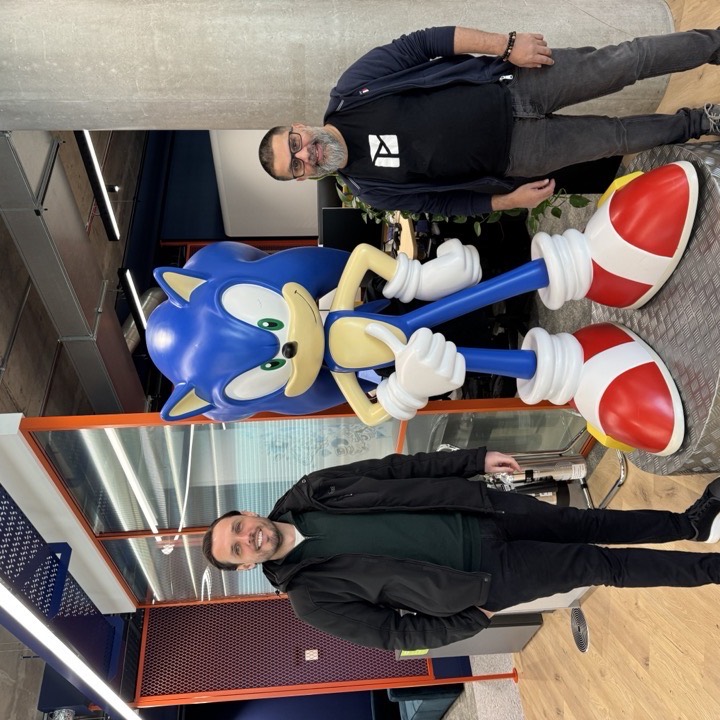 With a Sonic the Hedgehog statue at an office